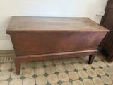 an old wooden chest sitting on top of a tiled floor