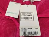 a close up of a pink shirt with a price tag on it