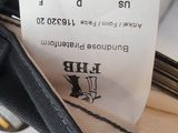a person holding a black purse with a price tag on it