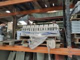 many stacks of plates on a shelf in a warehouse