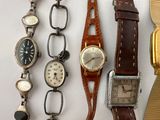 a lot of watches that are sitting on a table