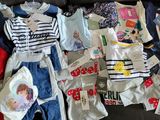 a lot of clothes that are on a black couch