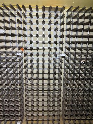 bottles of wine are arranged in a wine rack in a wine cellar