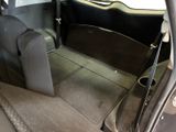 the back of a car with the door open and the passenger seat down
