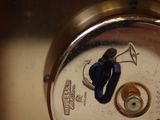 a close up view of a clock with a key on it