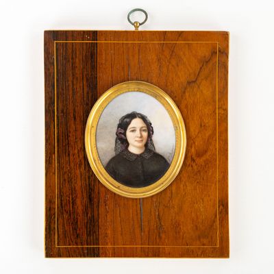 portrait d'une femme en robe noire dans un cadre en bois