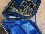 a blue case with a brass instrument inside of it