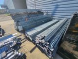 many piles of steel bars stacked on top of each other