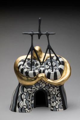 a black and white sculpture of two people on top of a building
