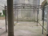 an image of a courtyard with a bench and a building in the background