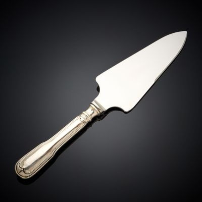 un couteau en argent avec un manche, sur fond noir