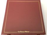 a close up of a red book with gold lettering on it