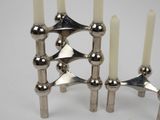 a silver candle holder with five candles on it