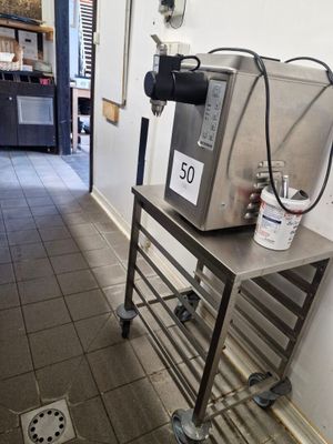 an image of a coffee machine on a cart in a coffee shop