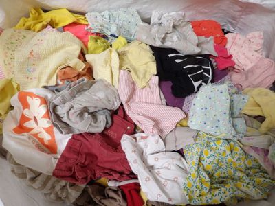 un tas de vêtements qui se trouve dans un sac blanc