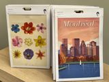 two magazines on a wooden table with a cityscape in the background