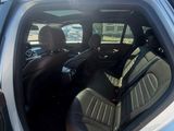 a silver car with the door open and the driver ' s seat up