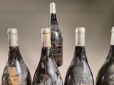 several bottles of wine are lined up on a table