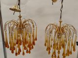 a pair of earrings that are hanging from a rack