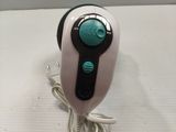 a white and black hair dryer sitting on a table