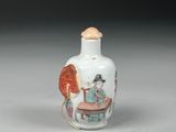 a small white vase with a picture of a woman on it