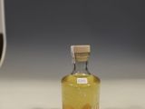 a small bottle of liquid sitting on a counter