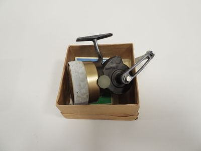 a box with a metal object in it on a white surface