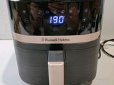 an image of a close up of a person taking a picture of an air fryer