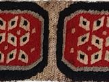 an image of a red and black rug with a pattern on it
