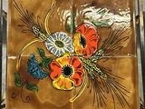 an image of a decorative tile with flowers on it