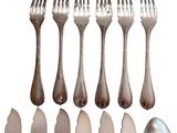 a lot of forks and spoons on a white background