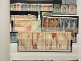 a display of stamps and stamps on display in a glass case