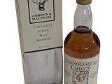 a close up of a bottle of whisky next to a box
