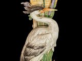 a bird that is sitting on a vase with flowers