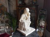 a statue of a woman sitting on top of a table