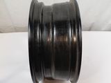 a close up of a black wheel on a white surface