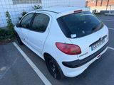 une petite voiture blanche garée dans un parking