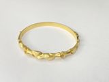 a close up of a gold ring on a white surface