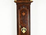 a grandfather clock that is standing in the corner of the room