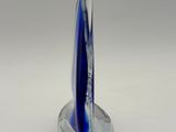 a blue glass sailboat on a clear base