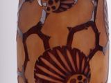 a vase with a flower design on it on a table