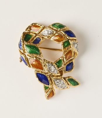 une image représentant une broche en or sertie de pierres multicolores