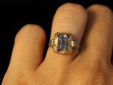 a close up of a person ' s hand with a ring on it