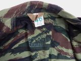 a close up of a camouflage jacket with a tag on it