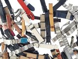 a lot of different types of belts on a white background