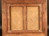 a close up of a wooden picture frame on a wooden stand