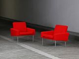 two red chairs sitting in the middle of a room
