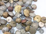 a pile of old buttons on a white surface