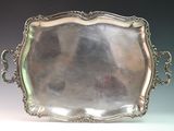 an antique silver tray with handles and handles on a table