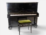 a piano and a stool sitting next to each other